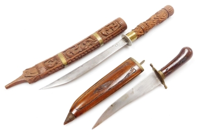 Two Indian knives, one with a carved wooden handle, engraved steel blade, and similarly carved scabbard with brass banding, 51.5cm wide, and a further knife with wooden handle, the steel blade stamped India, in a carved wooden scabbard, 33.5cm wide. - 8