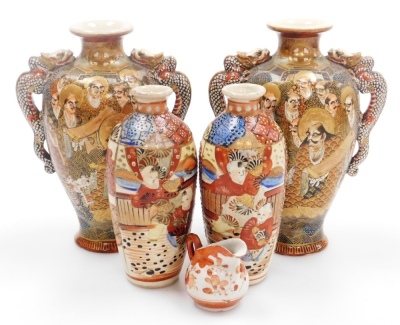 A pair of early 20thC Japanese Satsuma vases, each of baluster form with applied dragon handles, decorated with figures to both sides, marked Dai Nihon Satsuma to underside, 19.5cm high, together with another pair of Satsuma vases of cylindrical tapering - 19