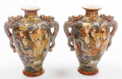 A pair of early 20thC Japanese Satsuma vases, each of baluster form with applied dragon handles, decorated with figures to both sides, marked Dai Nihon Satsuma to underside, 19.5cm high, together with another pair of Satsuma vases of cylindrical tapering - 22