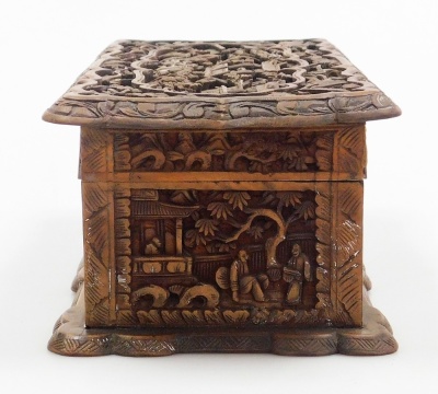 A 20thC Chinese Canton hardwood box, of rectangular shaped form, profusely carved with figures, buildings, trees, etc., the hinged lid enclosing a vacant interior, 25cm wide. - 11