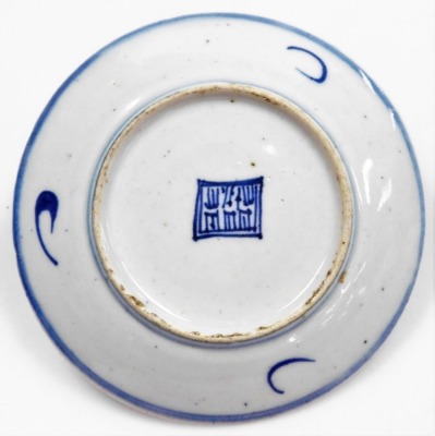 A Nanking Cargo blue and white tea bowl and saucer, painted with a landscape, bears label for Christies lot 5108, together with a 19thC blue and white saucer painted with flowers and foliate scrolls, seal mark, 14cm wide. (3) - 12