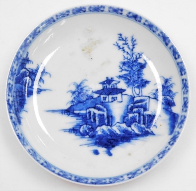 A Nanking Cargo blue and white tea bowl and saucer, painted with a landscape, bears label for Christies lot 5108, together with a 19thC blue and white saucer painted with flowers and foliate scrolls, seal mark, 14cm wide. (3) - 13