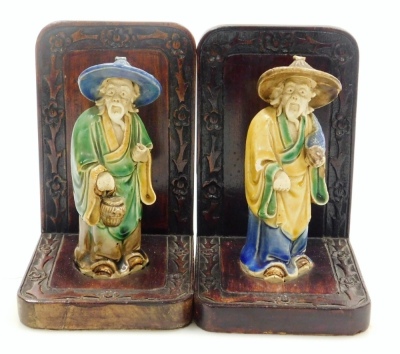 A pair of Chinese hardwood bookends, set with mudman figures and a carved floral border, 16cm high. - 8