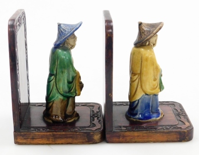 A pair of Chinese hardwood bookends, set with mudman figures and a carved floral border, 16cm high. - 9