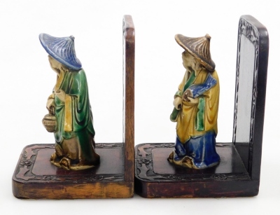 A pair of Chinese hardwood bookends, set with mudman figures and a carved floral border, 16cm high. - 11