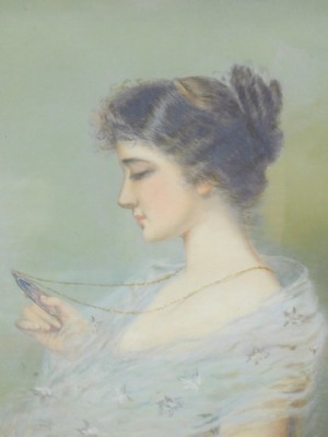 Edwardian School. Portrait of a lady looking at a portrait miniature, oil on Winsor & Newton canvas. unsigned, auction house vendor sticker and pencil marks verso, 37cm x 22cm.