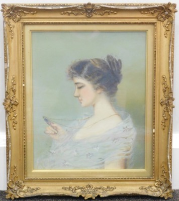 Edwardian School. Portrait of a lady looking at a portrait miniature, oil on Winsor & Newton canvas. unsigned, auction house vendor sticker and pencil marks verso, 37cm x 22cm. - 2