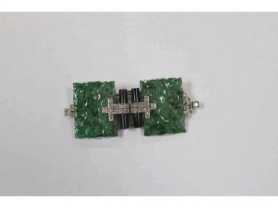 An Art Deco metamorphic brooch/clip comprising two carved jade panels of