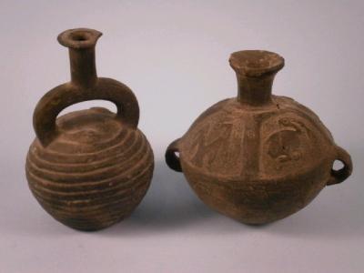 A pre Columbian two handled vessel decorated with birds and another with a coiled serpent