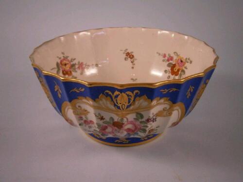 A mid 19thC Rockingham porcelain bowl painted with flower sprays on a blue and gilt ground