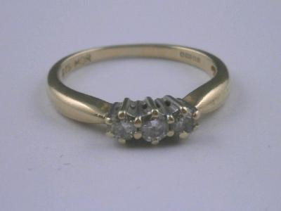 A 9ct gold ring set with three tiny diamonds