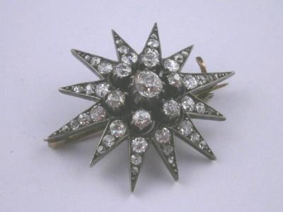 A Victorian star burst brooch set with old cut diamonds