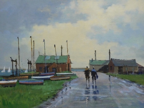 Thomas John Coates (b.1941). Sailors on a path before boats with boats on calm waters and boathouses in the distance, oil on board, attributed verso, 40cm x 49cm.