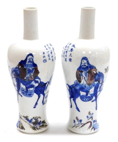 A pair of 19thC Chinese porcelain vases, of mallet form, decorated in underglaze blue and red with a sage on horseback in landscape before a bowing figure and a cloaked figure, with six character Kangxi mark, 32cm high.