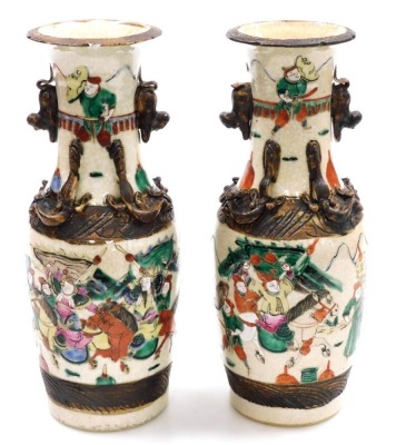 A pair of Chinese crackle glaze vases, of baluster form, with applied dog of fo handles and chilin to the neck, the body depicting a battle scene with figures on horseback, four character mark, 29.5cm high. - 3