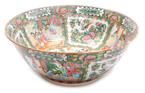 An early 20thC Chinese porcelain famille rose bowl, decorated with reserves of figures in interior scenes, birds, butterflies and flowers, stamped Made in China, 37.5cm diameter.