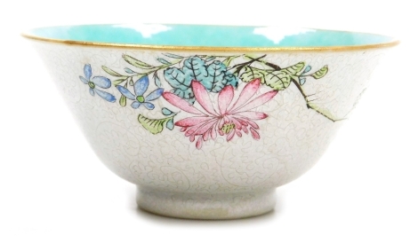 A Chinese Qing dynasty porcelain bowl, with a turquoise glaze interior, the exterior decorated in enamels in sgraffito with flowers on a white sgraffito ground, four character Qianlong blue mark to underside, probably 19thC, 9.5cm diameter.