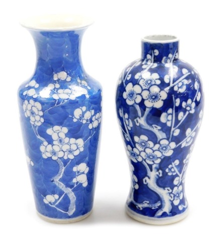 A Chinese blue and white vase, of baluster form, decorated with blossoming prunus on a cracked ice ground, bears Kangxi mark, 19cm high, and another similar, 20cm high, probably both 19thC.