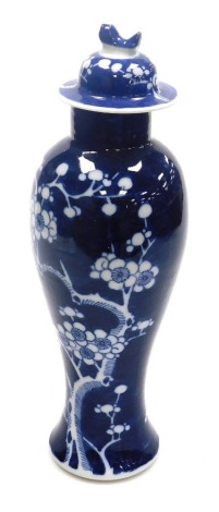 A 20thC Chinese porcelain vase and cover, of baluster form, decorated with flowering prunus against a cracked ice ground, 38cm high, (AF).