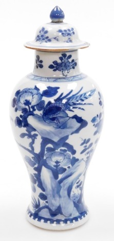 A 19thC Chinese porcelain blue and white vase and cover, of baluster form, decorated with a phoenix on tree surrounded by flowering branches, unmarked, 29cm high, (AF).