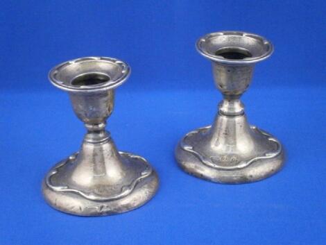 A pair of silver dwarf candlesticks