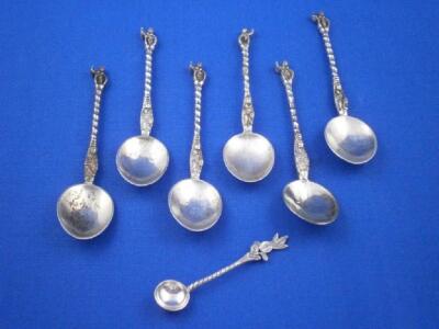 A set of six continental white metal Apostle type tea spoons and a salt spoon