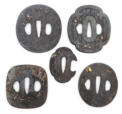 Five Japanese iron tsuba, each of differing shape and design, with silver and gold inlays.