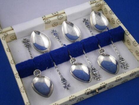 A set of six white metal teaspoons