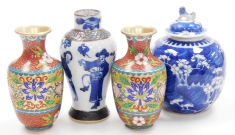 A pair of 20thC Chinese cloisonne vases, of shouldered form, decorated with leaves and flowers, 16cm high, a Chinese porcelain jar and cover, with dog of fo finial, decorated with prunus on a cracked ice ground, 18cm high, and an Oriental porcelain vase o