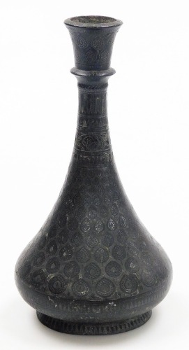 An early 20thC Indian iron vase, with silver inlay, of pear form, decorated with repeating leaf motifs and dog tooth banding, 20.5cm high.