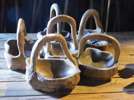 Six carved teak baskets, each approx 30cm high. Note: VAT is payable on the hammer price of this lot at 20%.