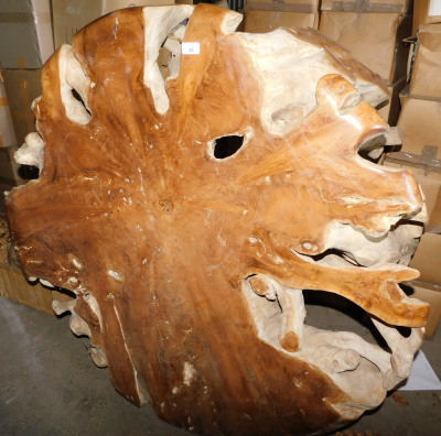 A teak root coffee table, 53cm high, the top 120cm diameter. Note: VAT is payable on the hammer price of this lot at 20%.