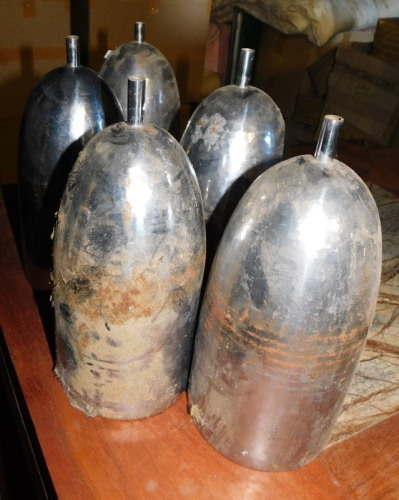 Five hammered metal light shades, of cylindrical elongated form, with copper coloured interior, 29cm high. Note: VAT is payable on the hammer price of this lot at 20%.