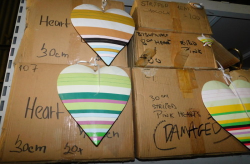 A group of painted wooden heart hanging decorations, each in differing colours of stripes, 30cm and 8cm. (6 boxes) Note: VAT is payable on the hammer price of this lot at 20%.