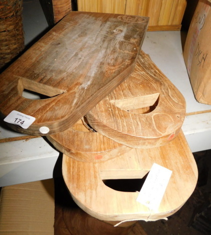 Four reclaimed teak chopping boards, each with a cut out handle, the largest 45cm x 22cm. Note: VAT is payable on the hammer price of this lot at 20%.