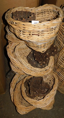 A quantity of wicker heart shaped baskets, each with a raised side, the largest 39cm wide. Note: VAT is payable on the hammer price of this lot at 20%.