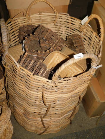 A large wicker log basket, with four ring handles, 88cm high, and a variety of woven and heart shaped baskets. Note: VAT is payable on the hammer price of this lot at 20%.