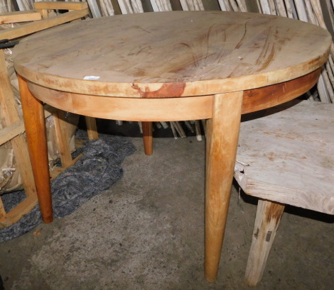 A reclaimed teak dining table, with circular top, on tapering legs, 76cm high, the top 110cm diameter. Note: VAT is payable on the hammer price of this lot at 20%.