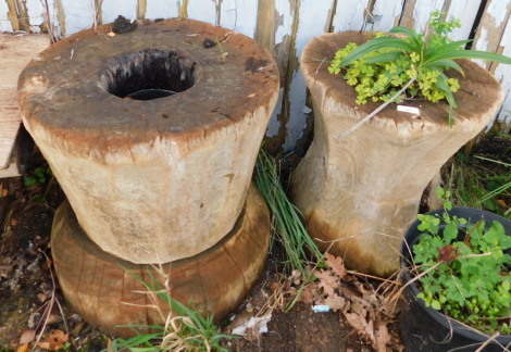 A Japanese hardwood rice pounder, 50cm, and another similar, of waisted form, 42cm high. Note: VAT is payable on the hammer price of this lot at 20%.