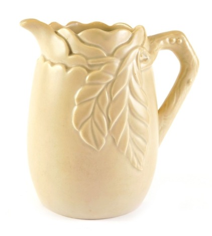 A Clarice Cliff brown glazed relief modelled jug, decorated with leaves and a branch, printed mark to underside, 20cm high.