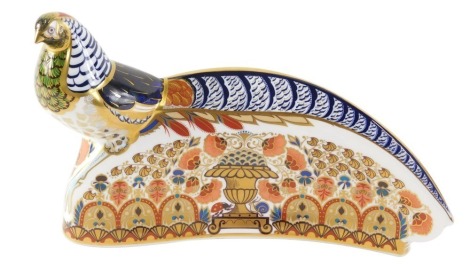 A Royal Crown Derby ceramic model of a pheasant, decorated in shades of blue, red and gilt, struck through red back stamp to underside and silver button, 30cm wide.