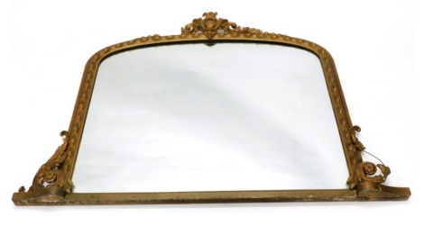 A Victorian gilt wood overmantel mirror, of D-end form, the plain glass surmounted by a heavily carved scroll and orb finial, the border set with flowers and further orbs, 107cm high, 112cm wide, 7cm deep.