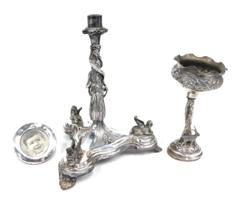 A silver plated part centrepiece with sphinx headed tricorn base, 26cm high, silver photograph frame and further silver centrepiece set with stag and entwined palm trees. (3)