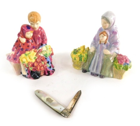 A Royal Doulton Street Vendors Flower Seller children figure, another Granny's Heritage, printed marks beneath, 10cm high, and a mother of pearl fruit knife with vacant shield shaped cartouche. (3)