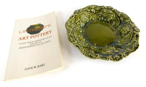 A Linthorpe pottery dish, raised with flowers in green glazes, No 1885, impressed marks beneath and Hart (Clive W) Linthorpe Art, book, paperback.