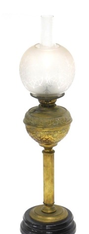 An early 20thC brass oil lamp, with frosted and clear glass shade, clear funnel, fluted stem and inverted circular base, 77cm high.