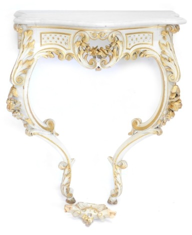 A Continental cream painted and parcel gilt console table, the white marble top with a moulded edge, above a pierced C scroll carved frieze, on elaborate cabriole legs decorated with flowers, scrolls, etc., joined by a shell carved under tier, 98cm high, 