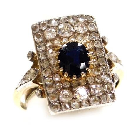 An Art Deco sapphire and diamond ring, set with an oval cut sapphire, rose and old cut diamonds in a yellow and white metal shank, size Q, 6.1g.