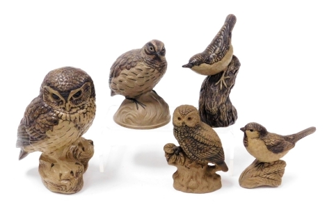 Five Poole buff pottery figures of birds, including a quail, owls, and a wren.