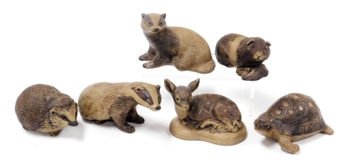 Six Poole buff pottery figures of animals, comprising two badgers, a guinea pig, a fawn, hedgehog and a tortoise.